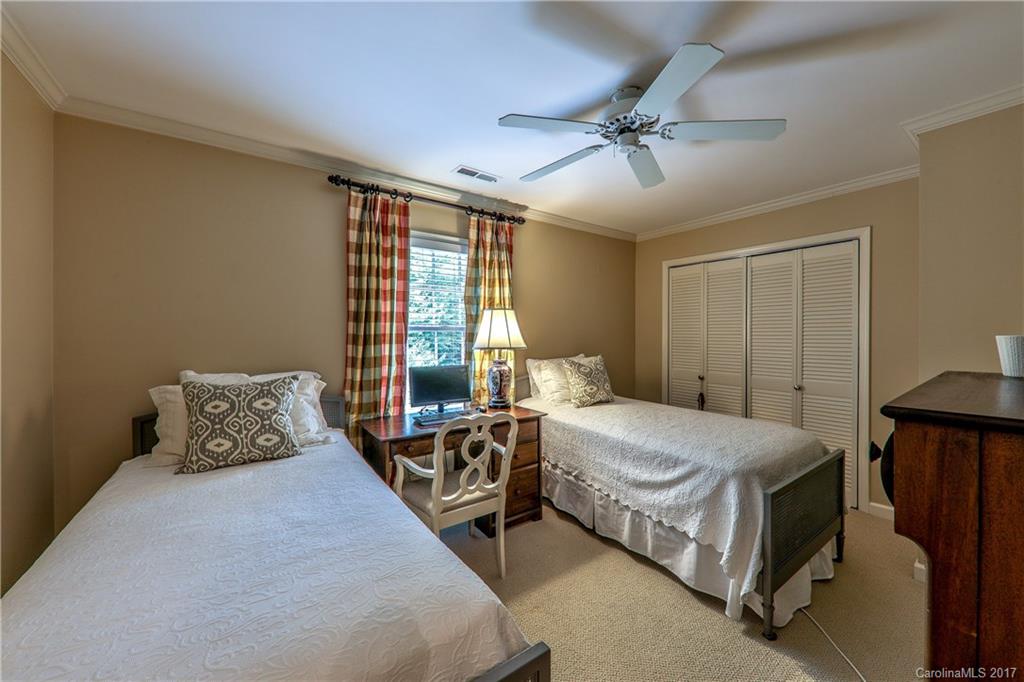 3214 Colony Road Charlotte, NC 28211 - Photo 17 of 24 a bedroom with a bed and a chandelier