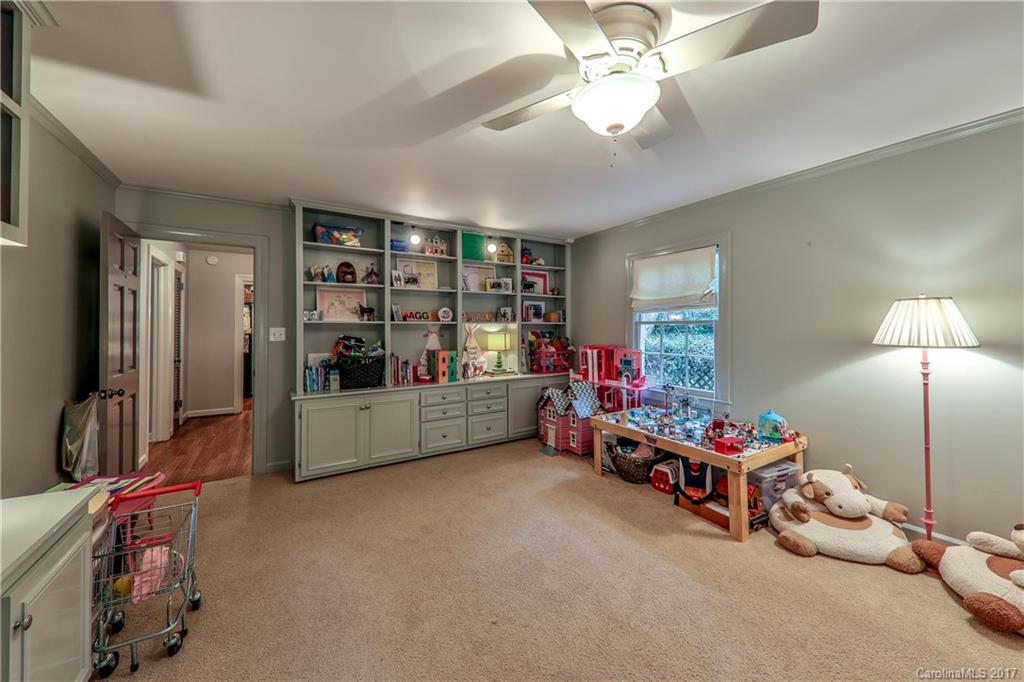 3214 Colony Road Charlotte, NC 28211 - Photo 20 of 24 a bedroom with furniture and a chandelier
