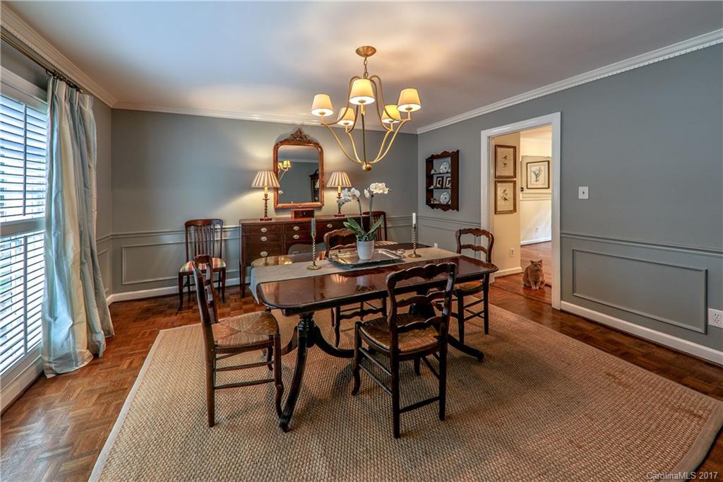 3214 Colony Road Charlotte, NC 28211 - Photo 4 of 24 a dining room with wooden floor a chandelier a wooden table and chairs