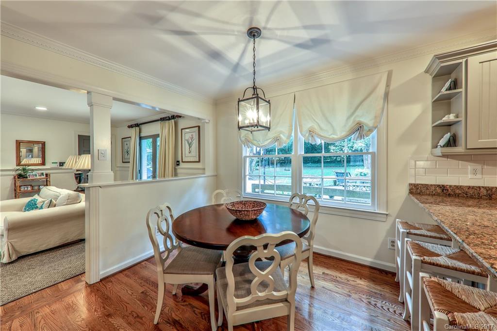 3214 Colony Road Charlotte, NC 28211 - Photo 9 of 24 a dining room with furniture a chandelier and wooden floor