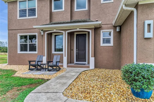a living room with furniture and a clock