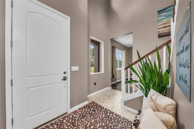 a kitchen with stainless steel appliances kitchen island granite countertop a stove a sink dishwasher a refrigerator and a dining table with wooden floor