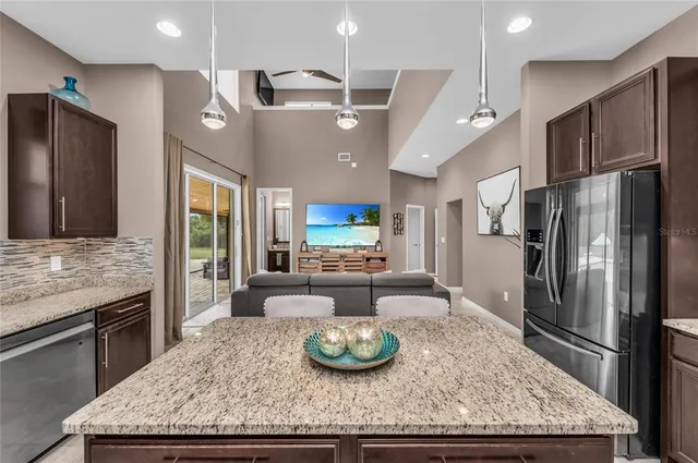 a view of a living room kitchen and a large window
