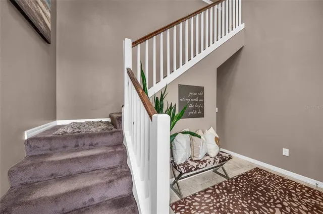 a view of swimming pool with a yard and large trees