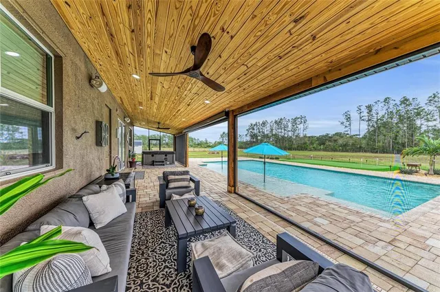 an aerial view of a city with lots of residential buildings ocean and mountain view in back