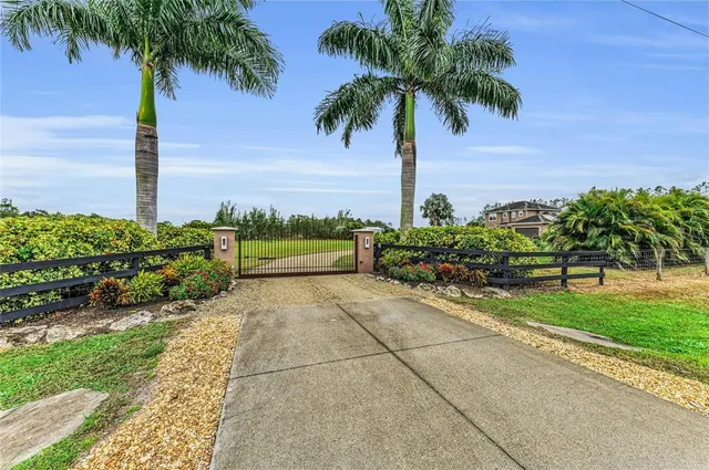 a view of a hallway to a livingroom with furniture and wooden floor