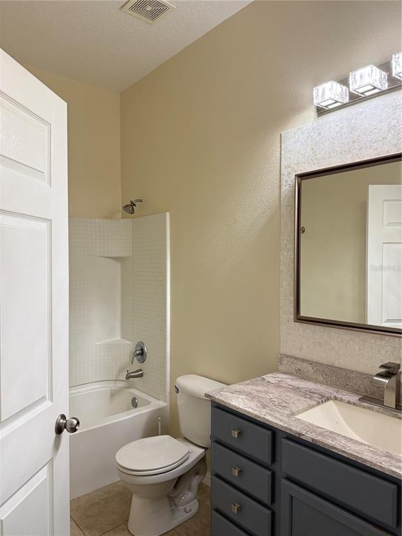 970 North Spring Garden Avenue, Unit 311 DeLand, FL 32720 - Photo 13 of 16 a bathroom with a granite countertop sink toilet and mirror