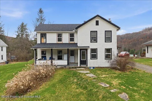 a front view of house with yard and green space
