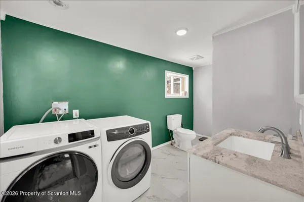 a utility room with dryer and washer