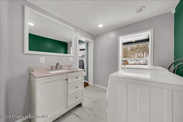 a bathroom with a sink a toilet and mirror