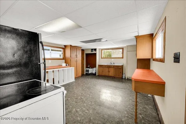 a living room with furniture and a kitchen