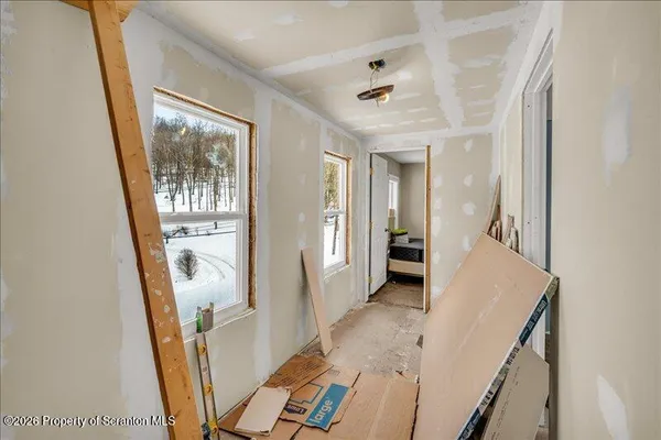 a view of an entryway with wooden floor and a livingroom