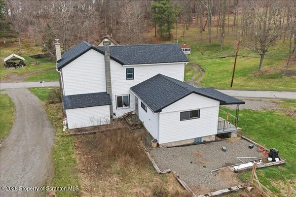 a aerial view of a house with a yard