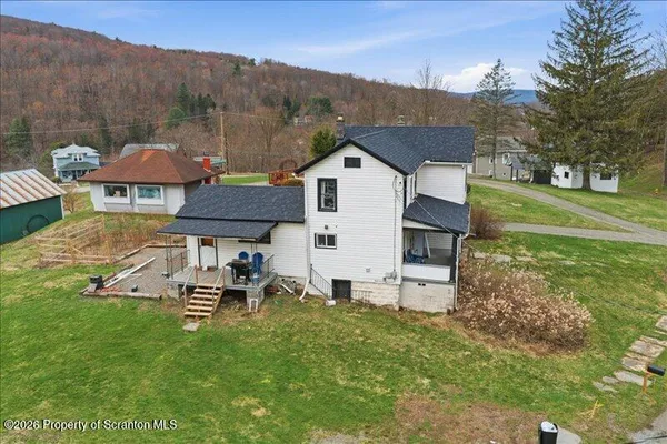 a view of a house with backyard sitting area and garden