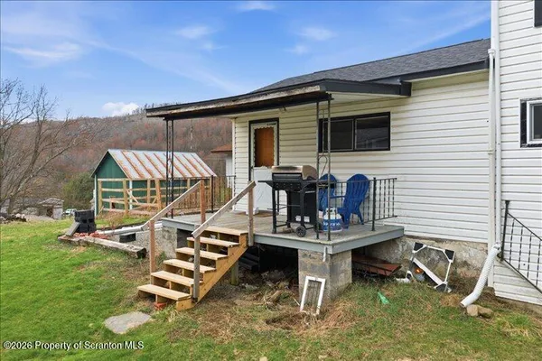 a view of backyard with a table and chairs