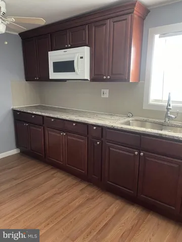 a kitchen with sink and cabinets