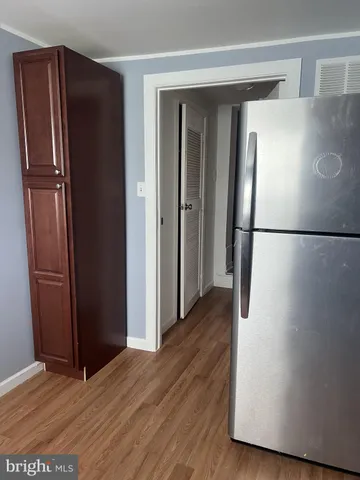a view of a refrigerator in kitchen and wooden floor