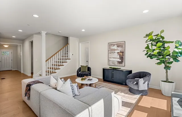 a living room with furniture and a potted plant