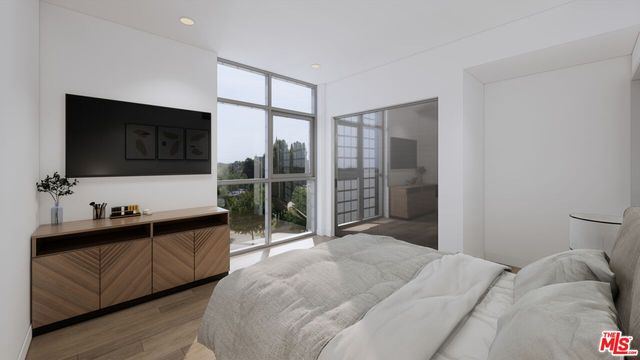 a bedroom with a bed and flat screen tv