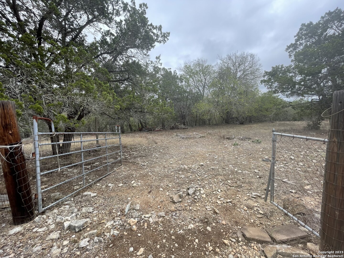 125 Pecan Drive Spring Branch, TX 78070 - Photo 3 of 12 a view of backyard with wooden fence