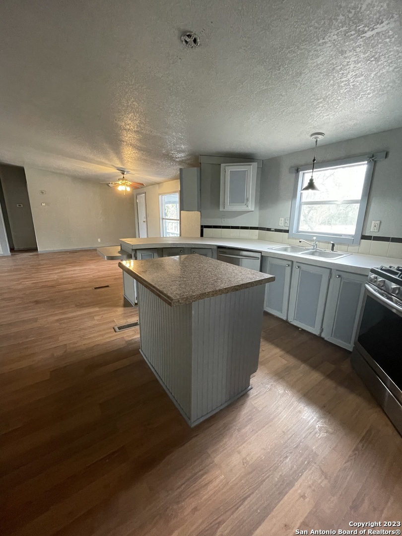 125 Pecan Drive Spring Branch, TX 78070 - Photo 8 of 12 a kitchen with stainless steel appliances granite countertop a sink and a stove top oven
