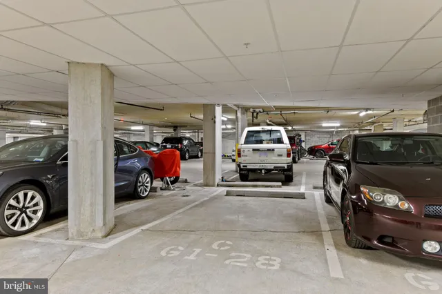 a view of parking garage with cars parked