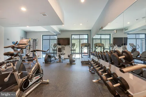 a room with gym equipment and a large window