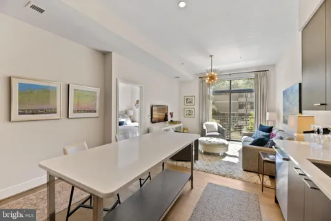 a living room with furniture a window and a table