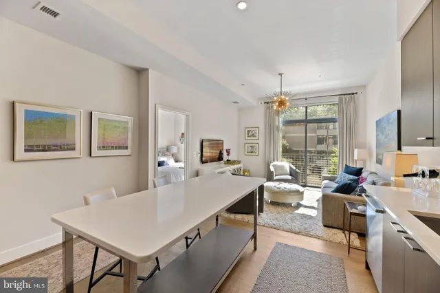 a living room with furniture a window and a table