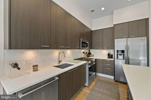a kitchen with a sink a stove and refrigerator