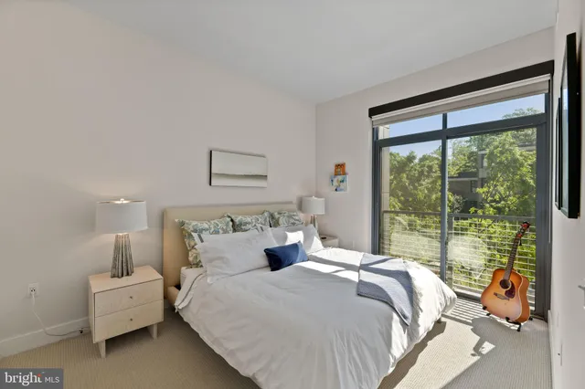 a bedroom with bed and glass door
