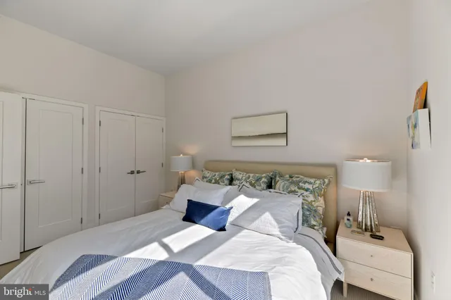 a bedroom with a bed and a night stand