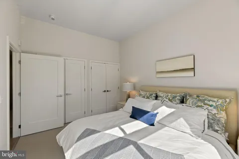 a bedroom with a bed and a painting