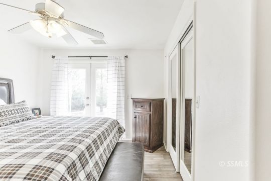 1214 North Guam Street Ridgecrest, CA 93555 - Photo 24 of 48 a bedroom with a bed and a chandelier