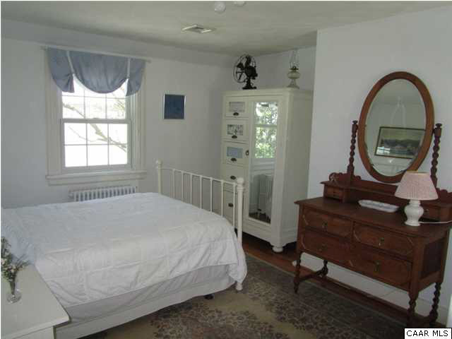 664 Horseshoe Bend Road Deltaville, VA 23043 - Photo 11 of 12 a bed sitting in a bedroom next to a window