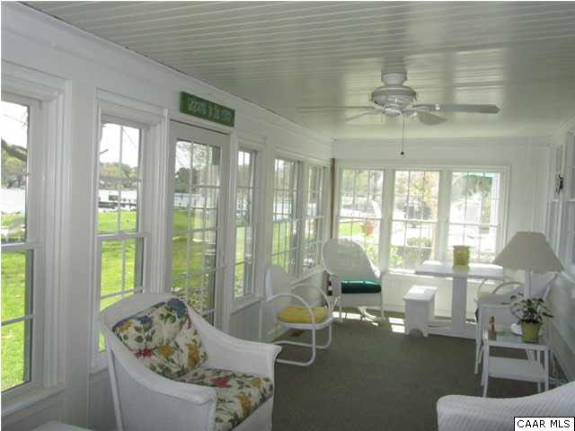 664 Horseshoe Bend Road Deltaville, VA 23043 - Photo 6 of 12 a living room with furniture and floor to ceiling windows