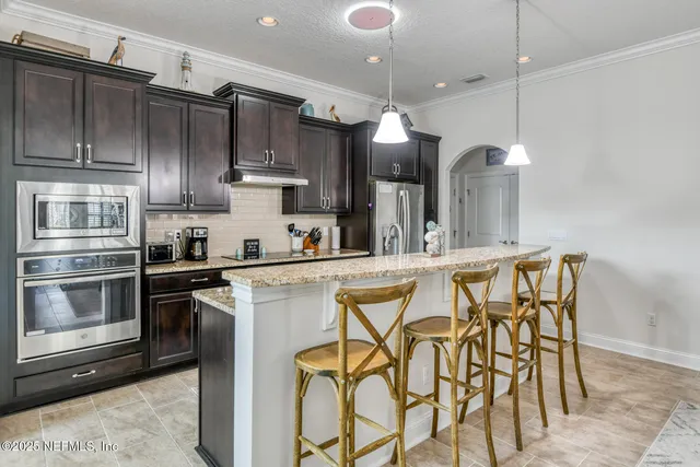 a view of a a dining room with furniture window and wooden floor