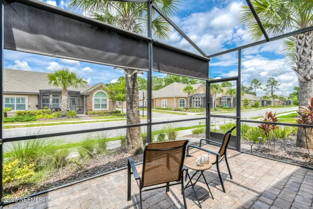 a view of a patio with table and chairs and potted plants