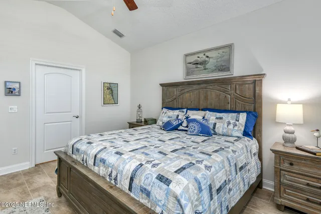 a bedroom with a bed and a television