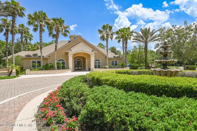 a view of a park with trees and wooden fence