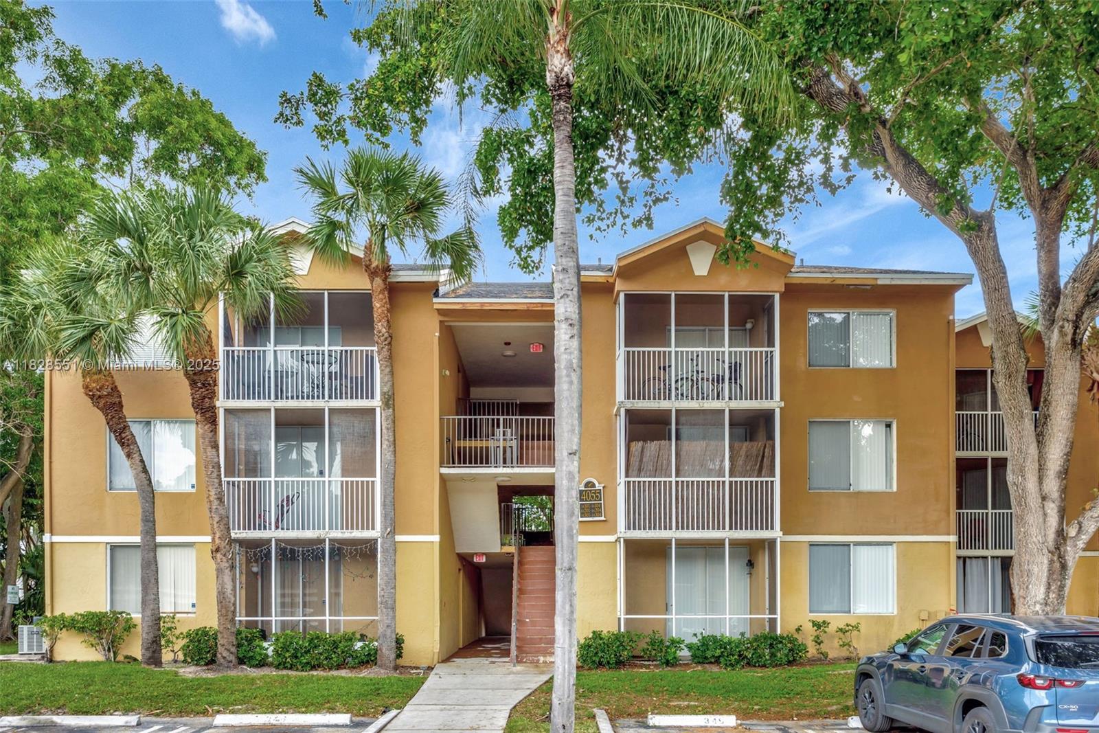 a front view of a residential apartment building with a yard