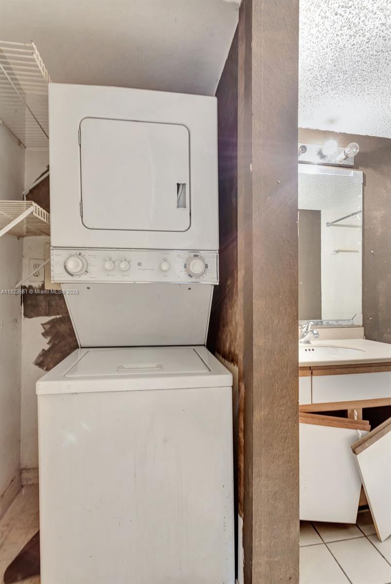 4055 West McNab Road, Unit H103 Pompano Beach, FL 33069 - Photo 11 of 21 a utility room with dryer and washer