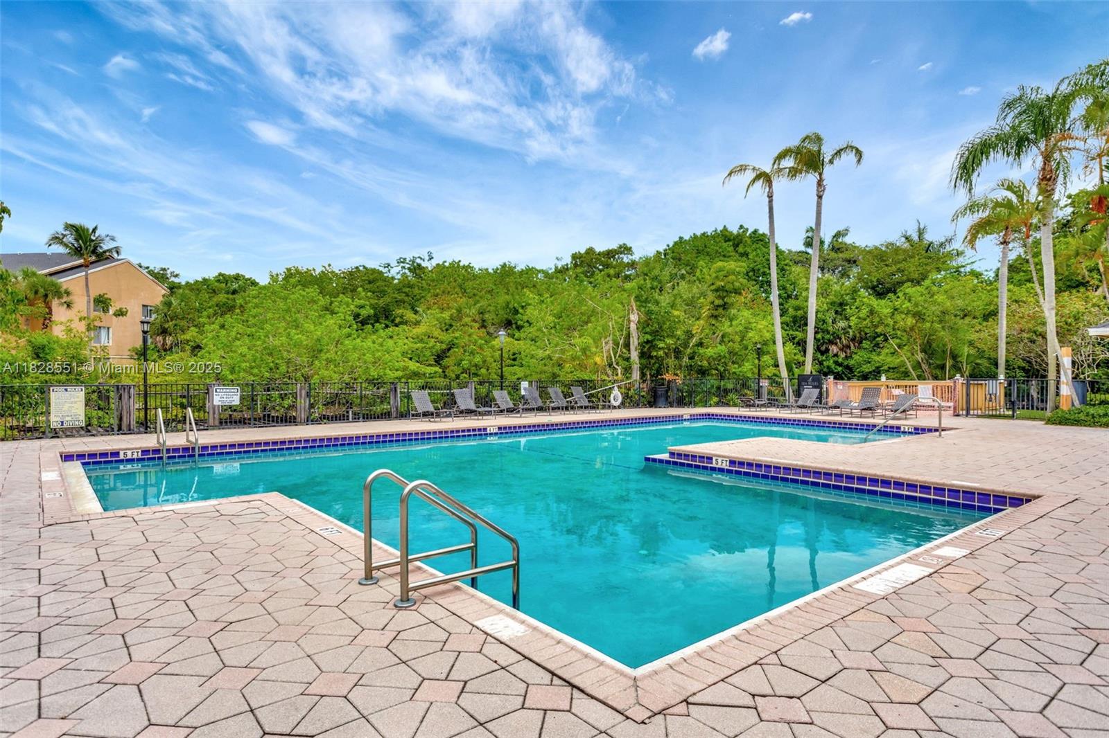 4055 West McNab Road, Unit H103 Pompano Beach, FL 33069 - Photo 19 of 21 a view of swimming pool with a garden and trees