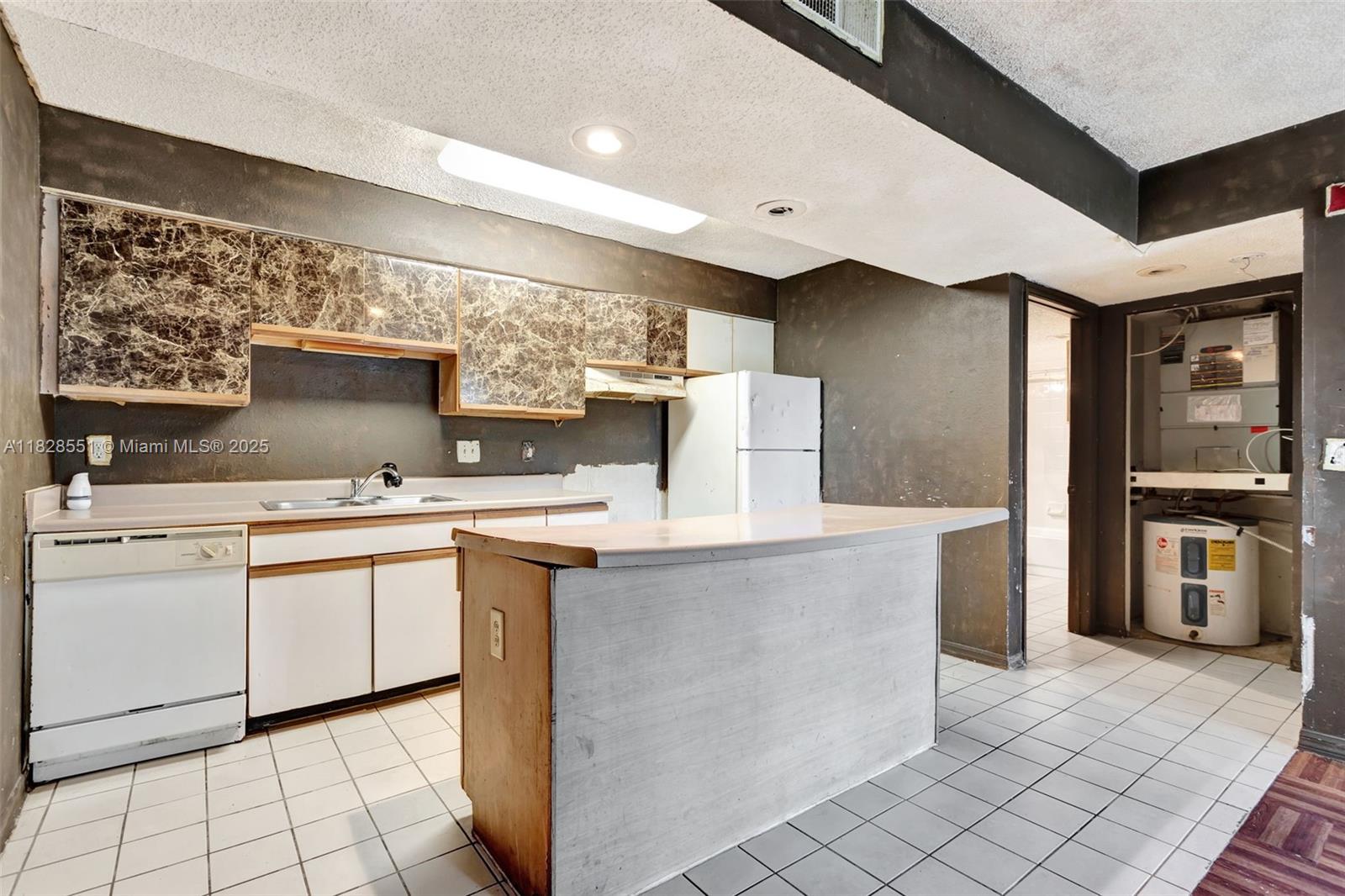 4055 West McNab Road, Unit H103 Pompano Beach, FL 33069 - Photo 5 of 21 a kitchen with stainless steel appliances granite countertop a sink counter space and cabinets
