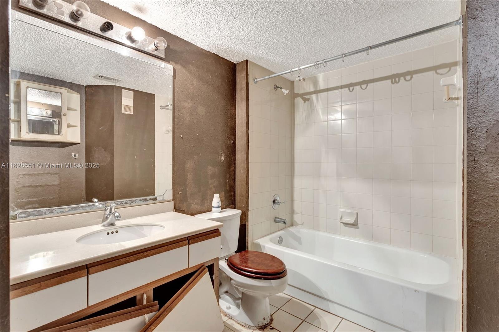 4055 West McNab Road, Unit H103 Pompano Beach, FL 33069 - Photo 10 of 21 a bathroom with a bathtub shower sink and toilet