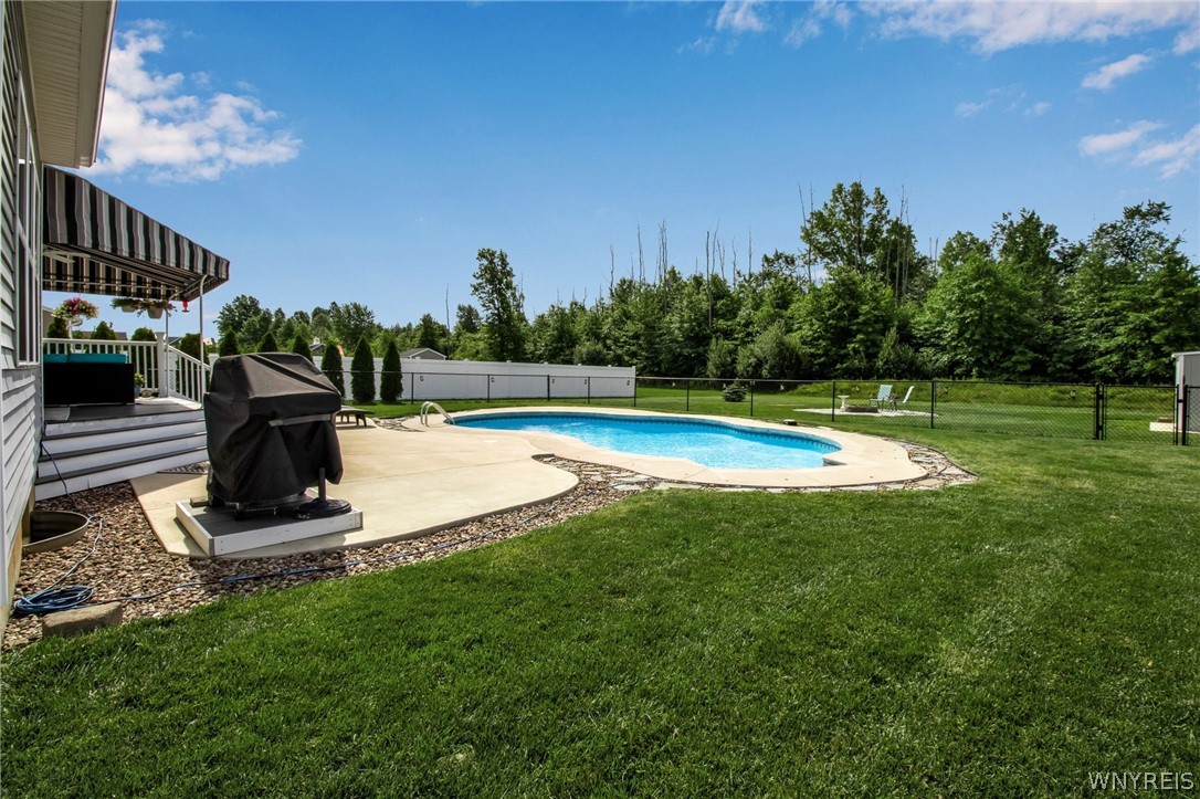 4978 Cloverleaf Lane Pendleton, NY 14094 - Photo 37 of 41 Fire pit and sheds are beyond the fence around the