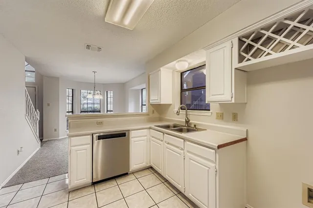 a kitchen with a sink cabinets and window