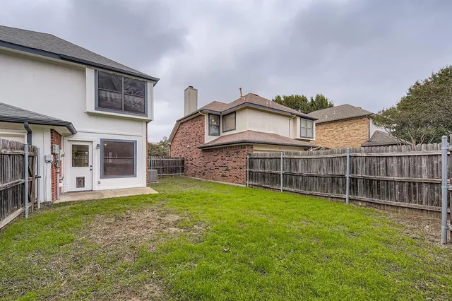 a view of a house with a yard and sitting area