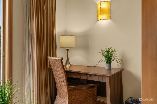 a living room with furniture a large window and a fireplace