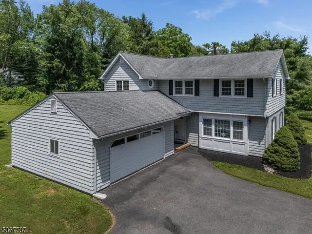 a aerial view of a house next to a yard